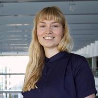 Portrait photo of Caecilie. She has blond hair and is wearing a dark blue shirt.