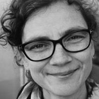 Photo of Stine Loft Rasmussen. Stine is wearing glasses and the picture is in greyscale