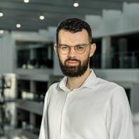 headshot of Robert Bayer against the background of ITU's building